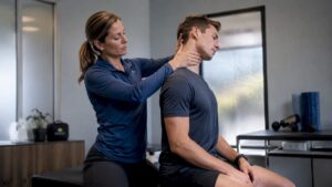 Physical therapist examining athlete's cervical spine