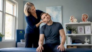Physical therapist performing vertigo maneuver on patient