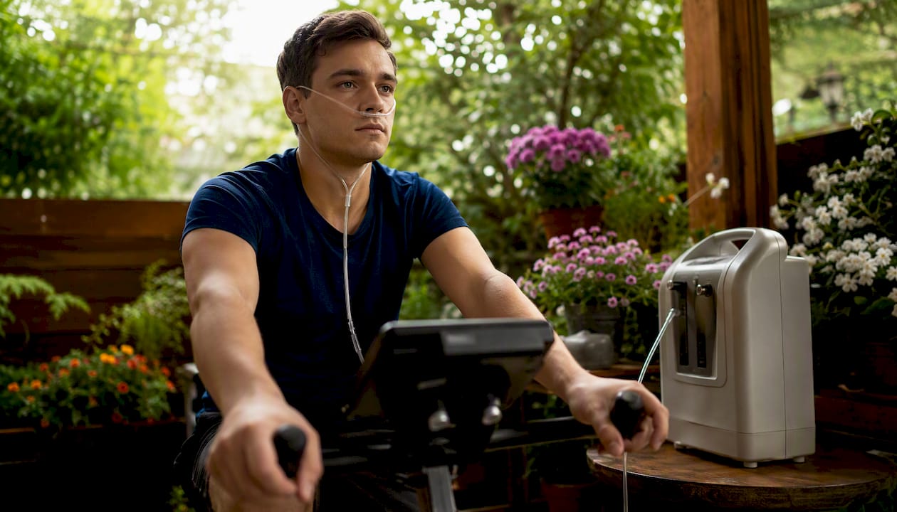Man exercising with oxygen therapy at home gym
