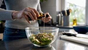 Hands pouring MCT oil into keto ingredients bowl