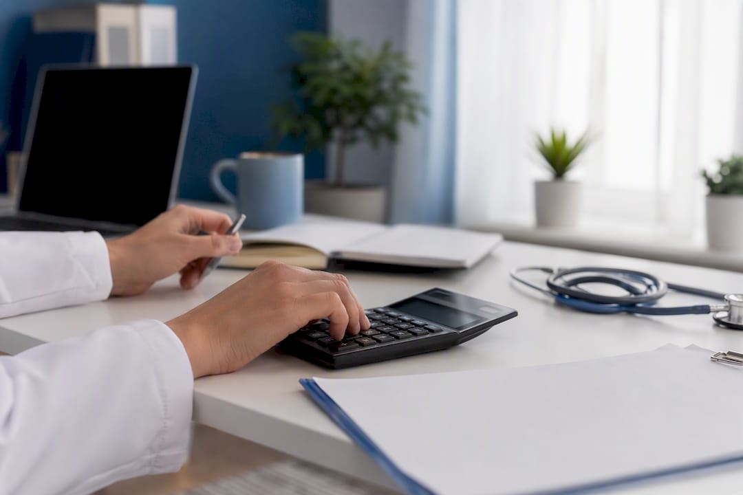 Hands calculating medical costs with calculator