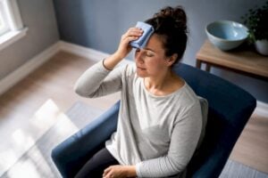 Person using a cool cloth while seated