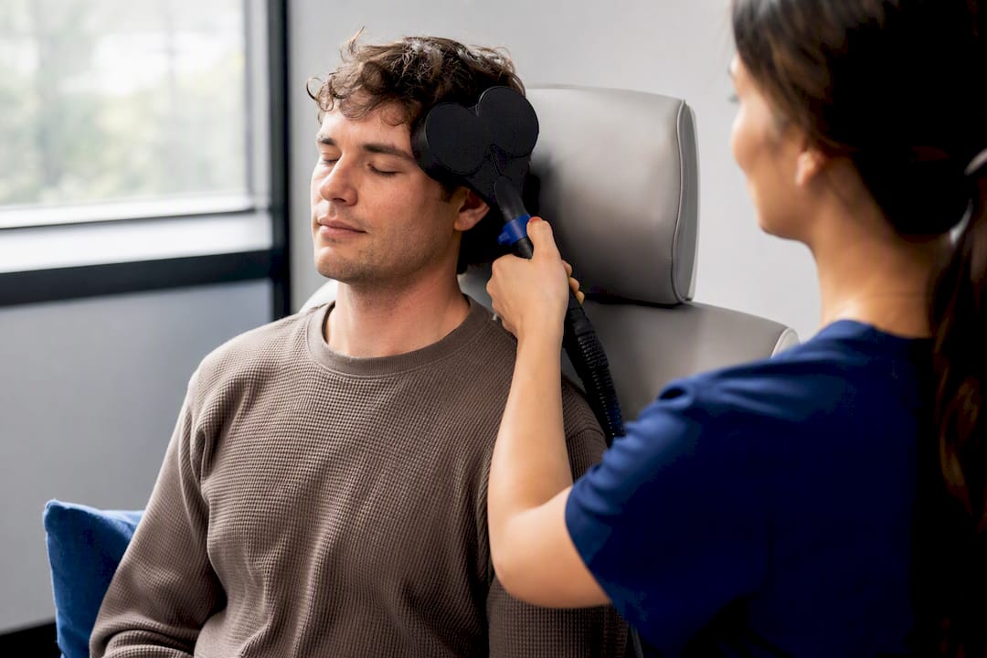 Patient receiving outpatient TMS treatment